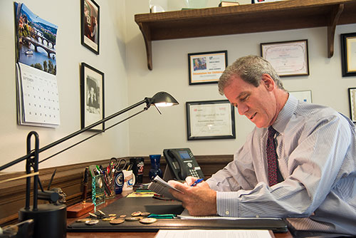 Roger sitting at his desk